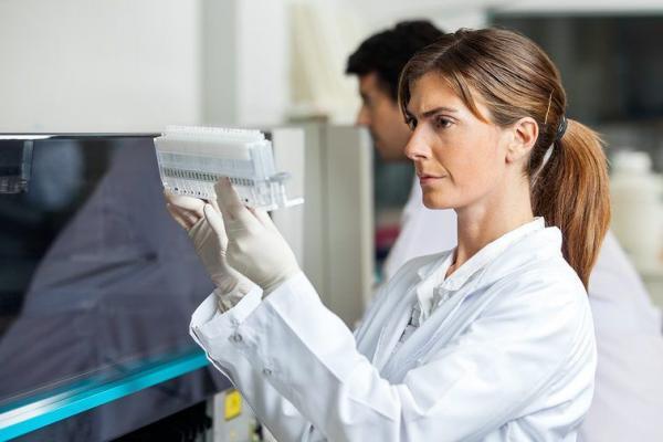 Researcher analysing samples in laboratory